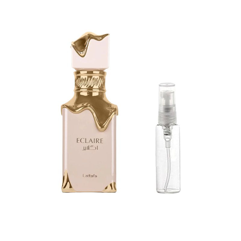 Perfume sample bottle with gold accents and clear travel spray vial