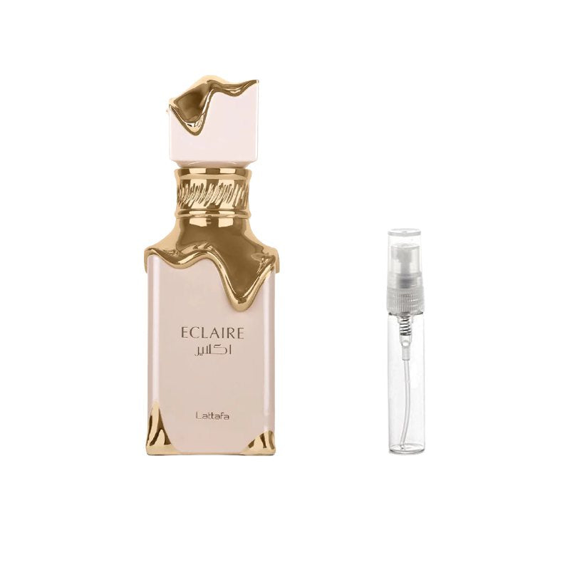Perfume sample bottle with gold cap, paired with a clear travel spray vial