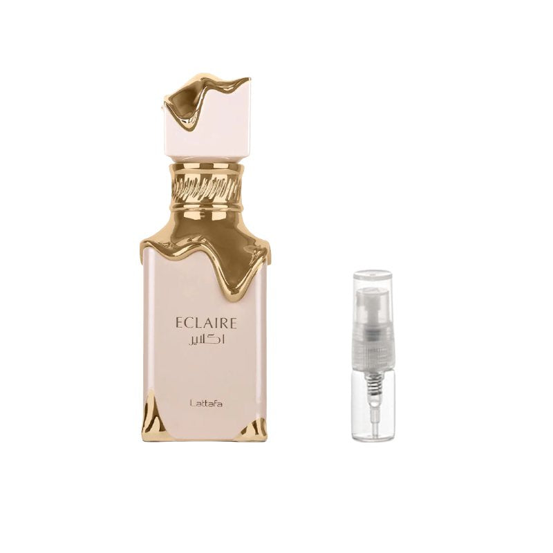 Perfume sample bottle with gold cap, shown with clear travel spray vial