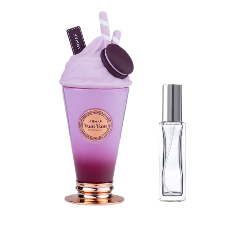 Clear glass perfume bottle with silver cap beside purple cup-shaped sample