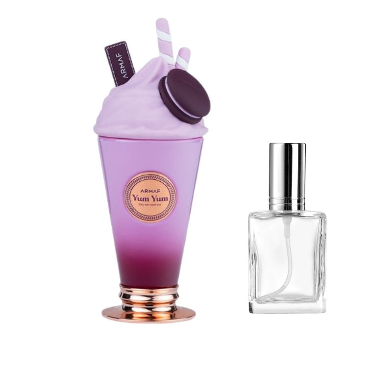 Clear glass perfume bottle with gold cap beside purple cup-shaped sample