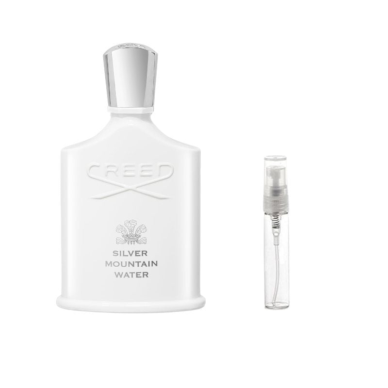 White sample perfume bottle with silver cap and small clear atomizer vial with nozzle