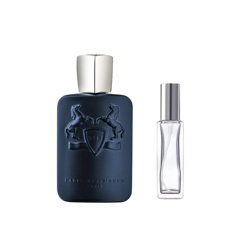 Dark blue perfume bottle with silver cap and crest, beside clear fragrance bottle with silver top