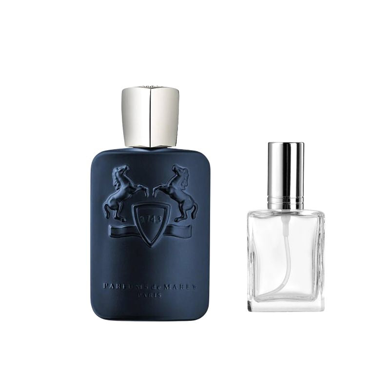 Dark blue perfume bottle with silver cap and embossed crest, beside clear bottle with silver cap