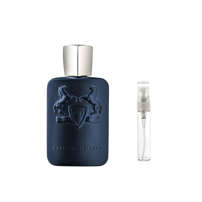 Dark blue perfume bottle with silver cap and crest, with clear travel spray vial