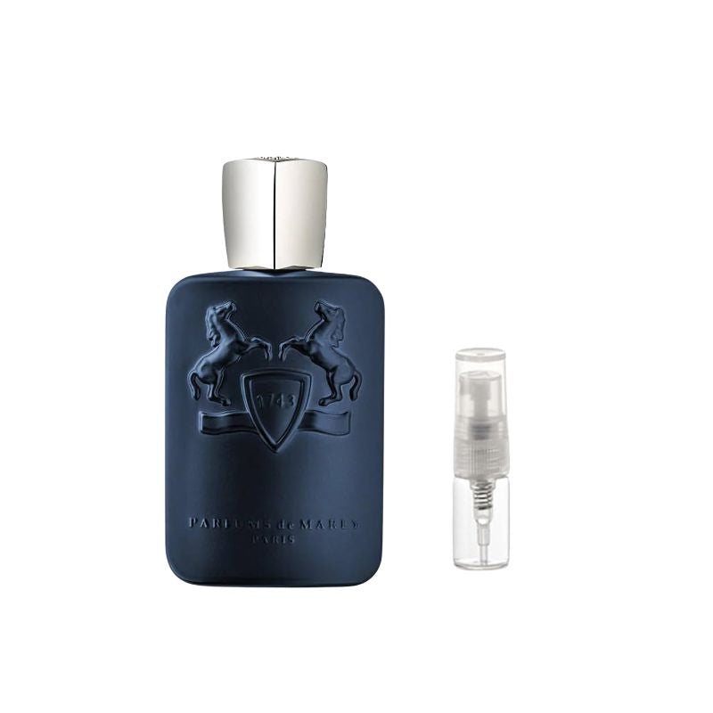 Dark blue perfume bottle with silver cap and embossed crest, with clear 2 ml spray vial