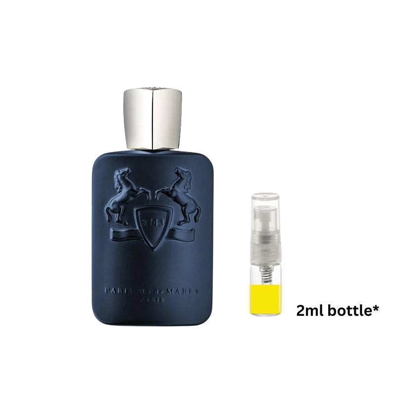 Dark blue perfume bottle with silver cap, plus 2 ml spray vial with yellow liquid