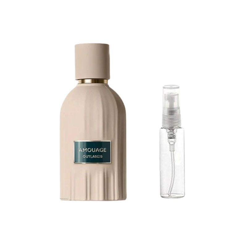 Perfume sample bottle with gold-toned cap and blue label, plus small spray bottle